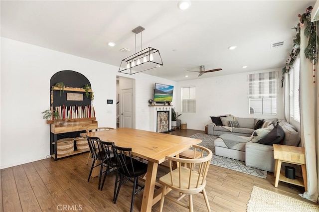 dining area featuring hardwood / wood-style flooring, ceiling fan, and a healthy amount of sunlight