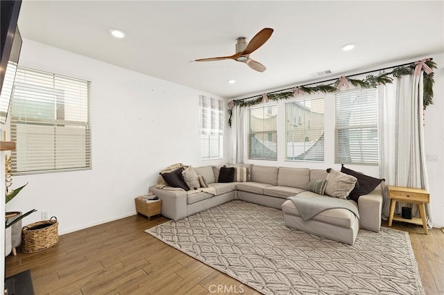 living room with ceiling fan and light wood-type flooring