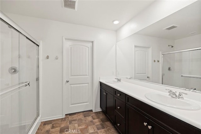 bathroom with vanity and a shower with shower door