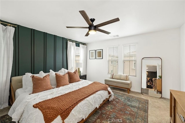 bedroom with ceiling fan and light colored carpet