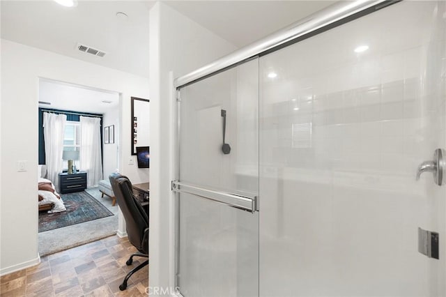 bathroom featuring a shower with door