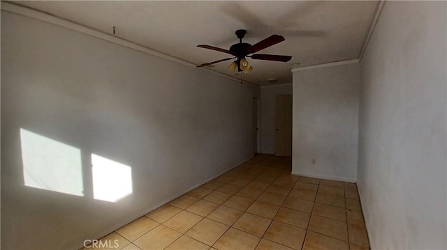 tiled spare room featuring crown molding and ceiling fan