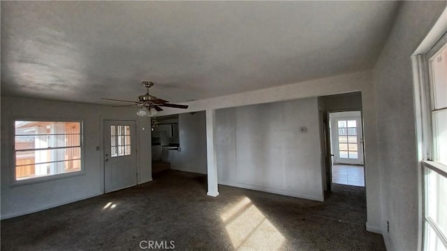 foyer featuring dark carpet and ceiling fan