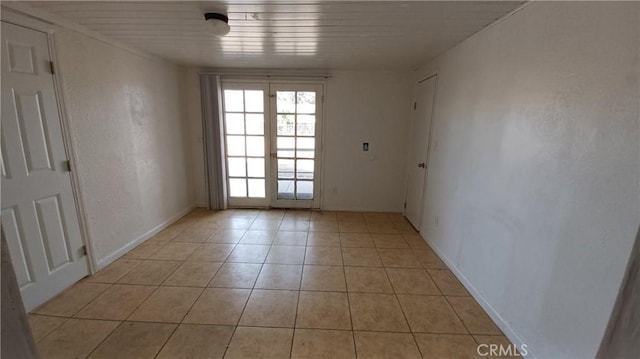 tiled spare room with wood ceiling