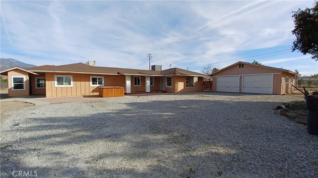 view of front of property with a garage and an outdoor structure