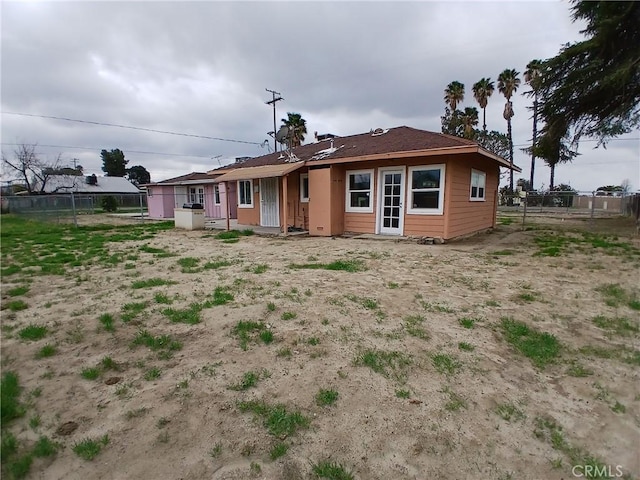 rear view of house with fence