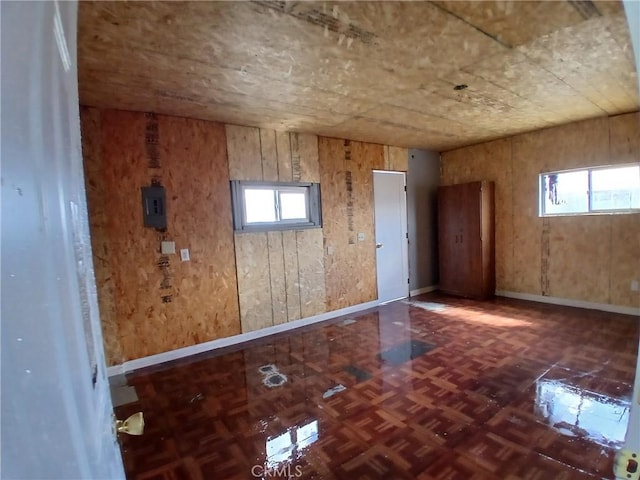 spare room featuring a wealth of natural light and baseboards