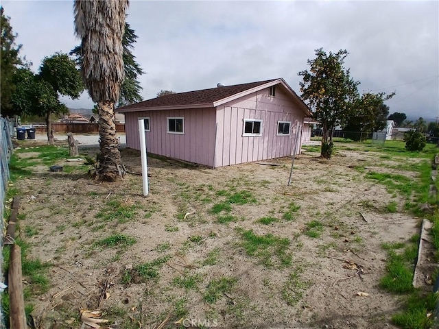 view of outbuilding featuring fence