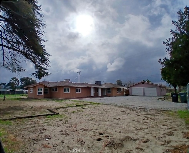 view of front facade with a garage and an outbuilding