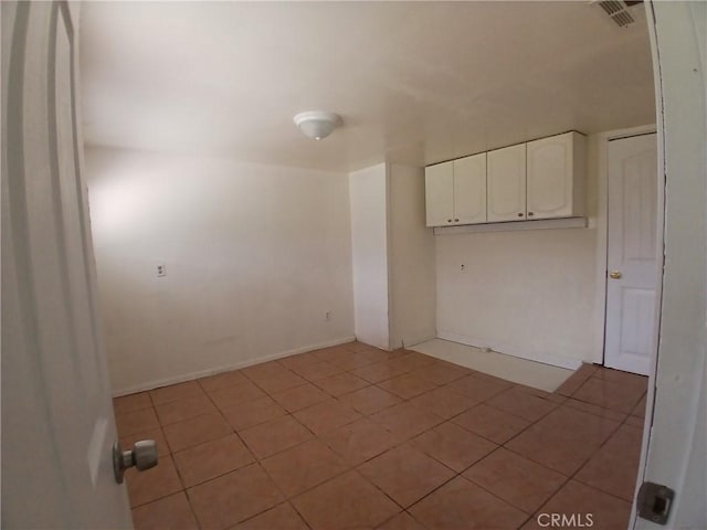 unfurnished room with visible vents and light tile patterned floors