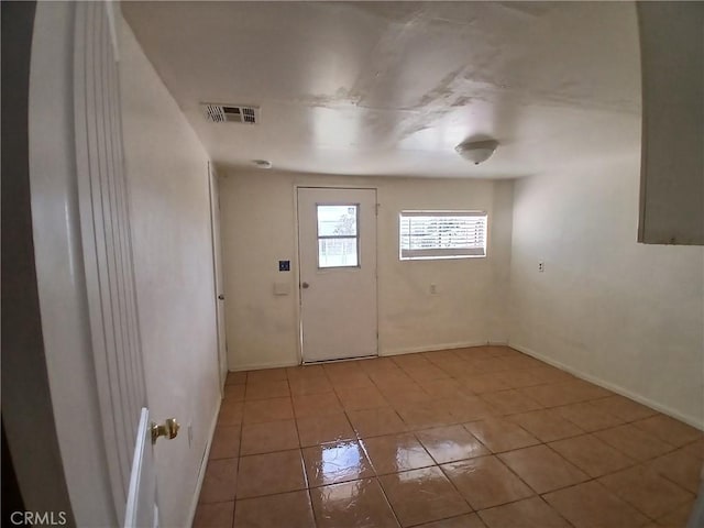 entrance foyer with baseboards, visible vents, and light tile patterned flooring