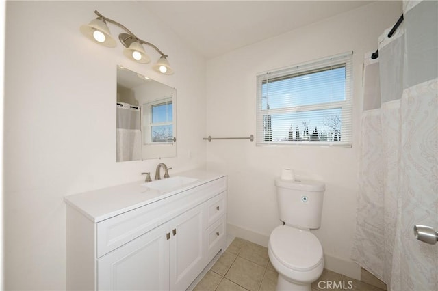 bathroom with vanity, tile patterned floors, and toilet