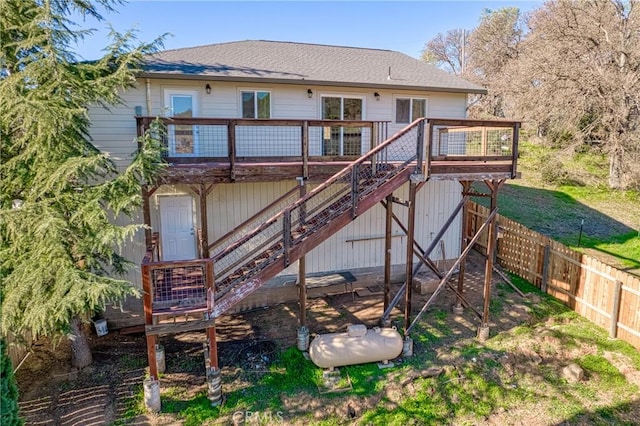 rear view of house featuring a wooden deck