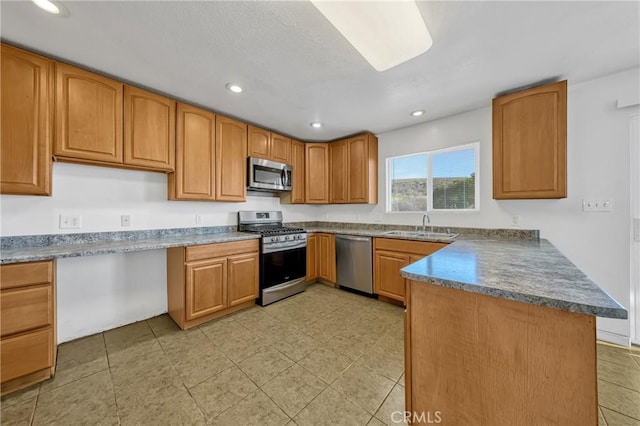 kitchen featuring sink, kitchen peninsula, and appliances with stainless steel finishes