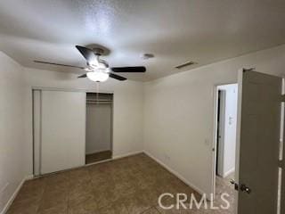 unfurnished bedroom with ceiling fan and a closet