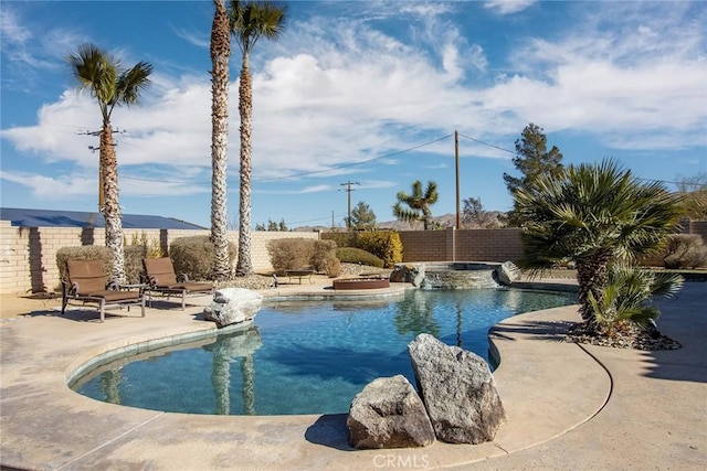 view of swimming pool featuring an in ground hot tub and a patio area