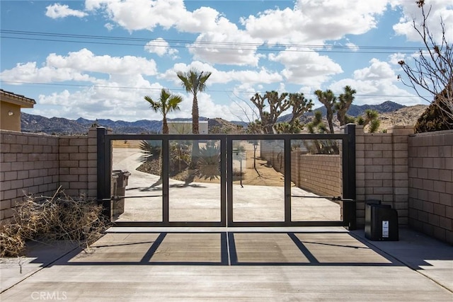 view of gate with a mountain view