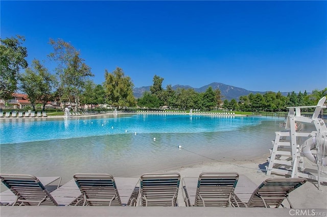 view of swimming pool with a mountain view