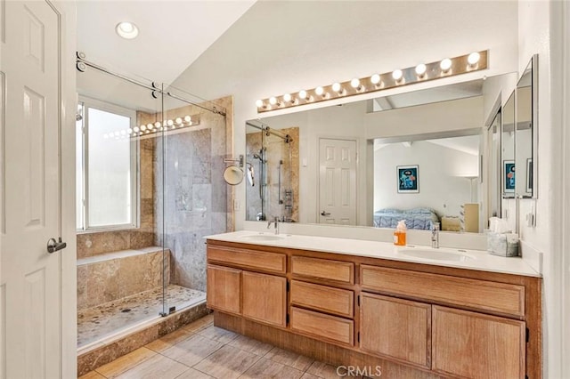 bathroom with vanity, lofted ceiling, an enclosed shower, and tile patterned floors