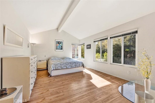 bedroom with vaulted ceiling with beams and light hardwood / wood-style floors