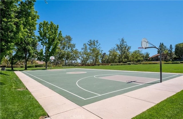 view of basketball court with a yard