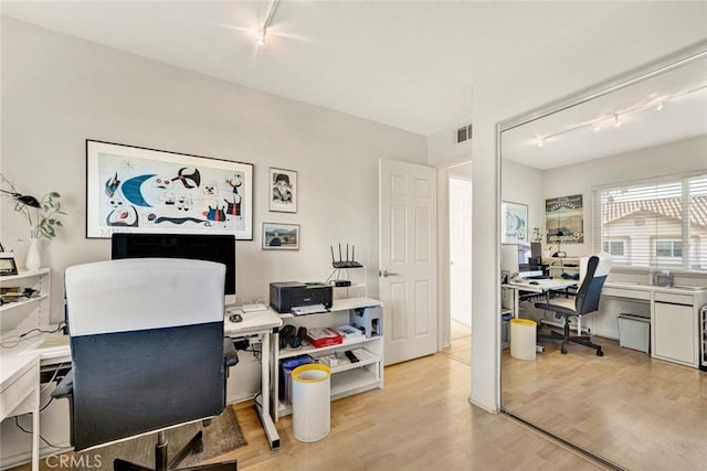 office featuring track lighting and light hardwood / wood-style flooring