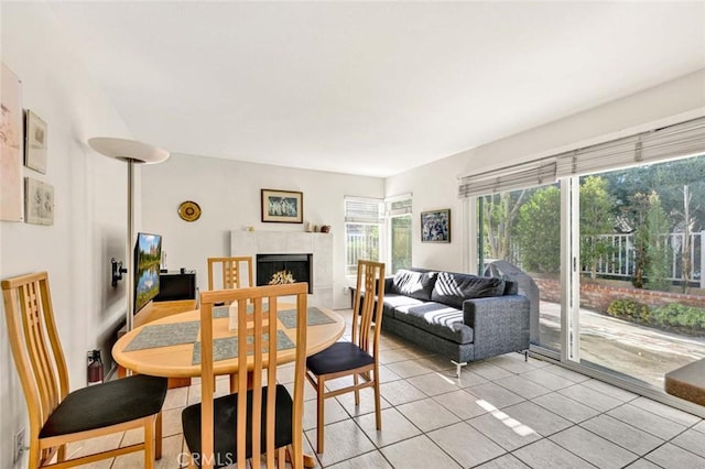 tiled dining room with a fireplace