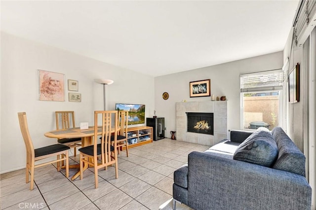 living room featuring light tile patterned flooring and a tile fireplace