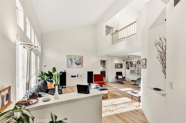 office area featuring high vaulted ceiling and light wood-type flooring