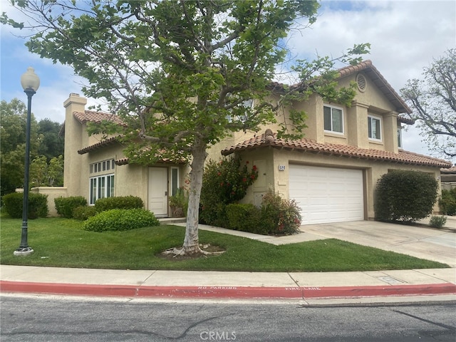 mediterranean / spanish-style home with a garage and a front yard