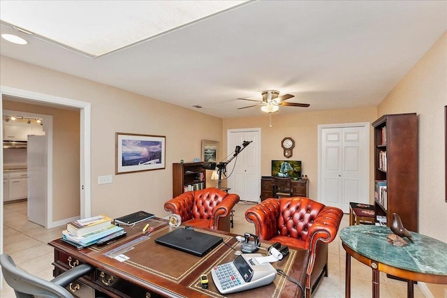 tiled office space featuring ceiling fan