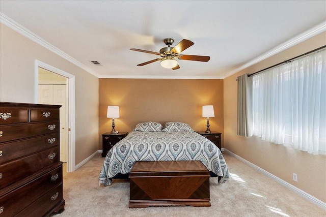 bedroom featuring ornamental molding, light colored carpet, and ceiling fan