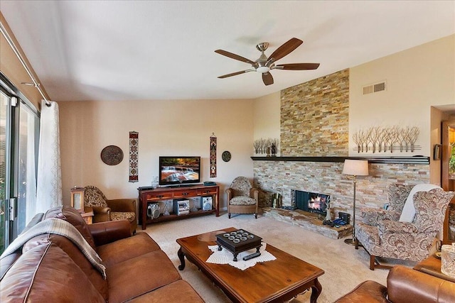 living room with ceiling fan, a fireplace, and light carpet