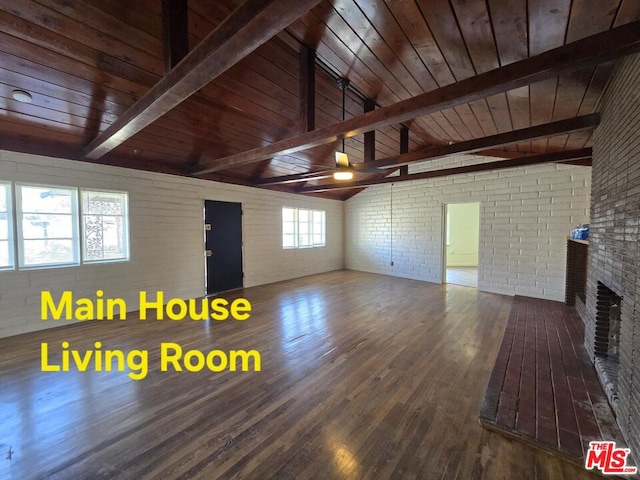 unfurnished living room featuring vaulted ceiling with beams, a brick fireplace, wooden ceiling, brick wall, and hardwood / wood-style floors