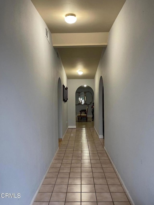 hall with light tile patterned floors