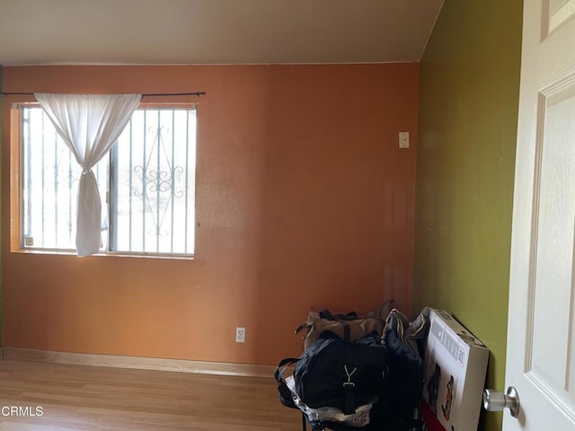 unfurnished room with wood finished floors