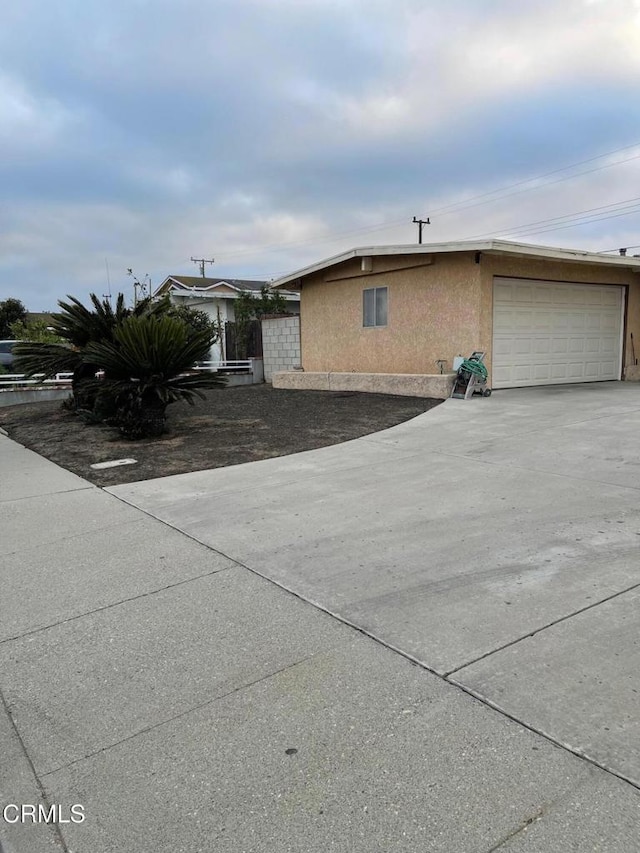 view of home's exterior with a garage and stucco siding