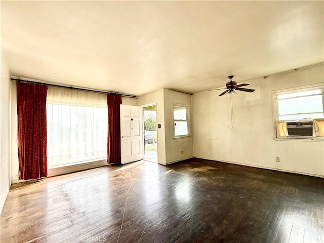 spare room featuring wood-type flooring, cooling unit, and ceiling fan