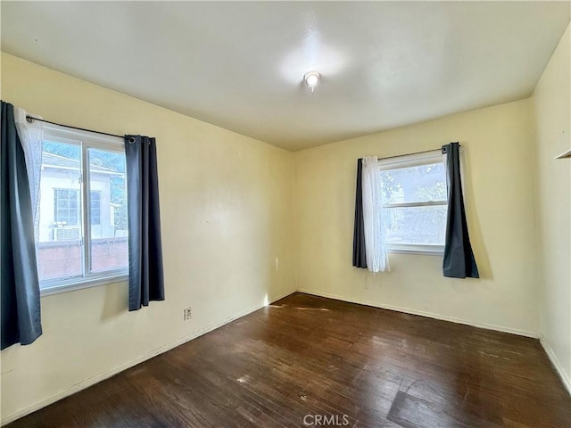 empty room featuring dark hardwood / wood-style flooring