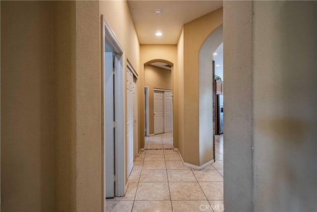 hall featuring light tile patterned flooring