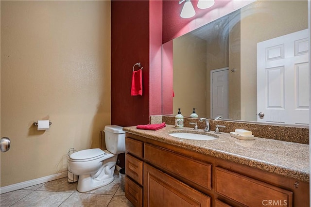 bathroom with tile patterned flooring, vanity, and toilet