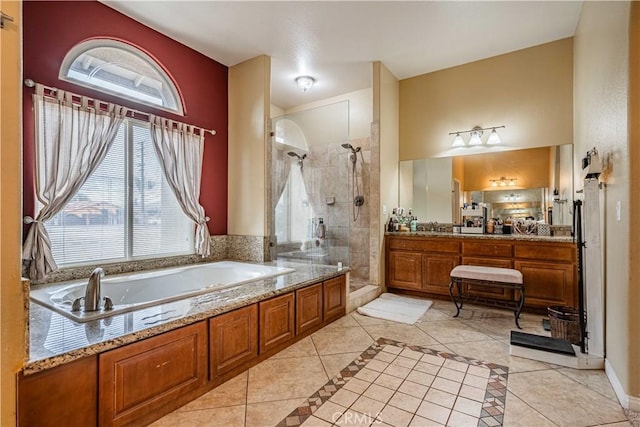 bathroom featuring tile patterned flooring, vanity, and separate shower and tub