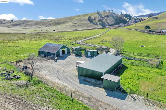 birds eye view of property with a mountain view and a rural view