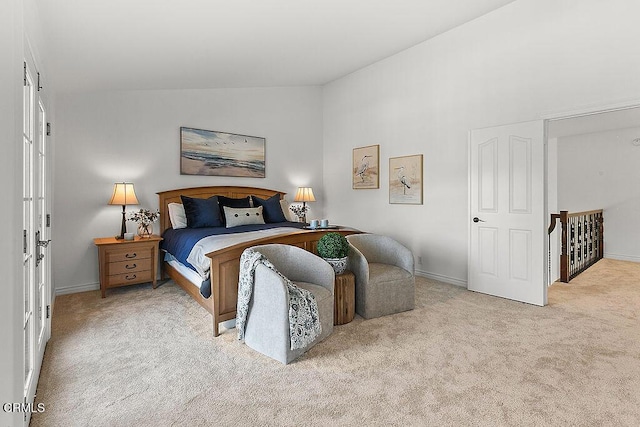 bedroom with light carpet and lofted ceiling