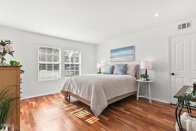 bedroom with dark hardwood / wood-style flooring