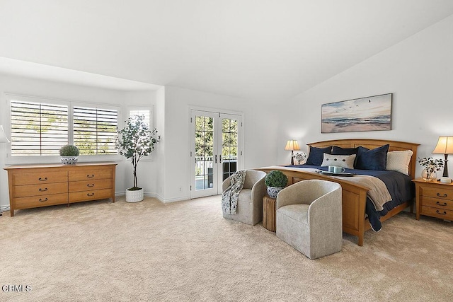 bedroom featuring french doors, lofted ceiling, light colored carpet, access to exterior, and multiple windows