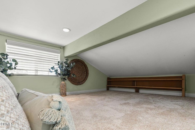 interior space with light carpet and vaulted ceiling with beams