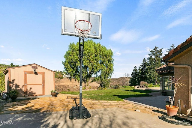 view of sport court with a lawn