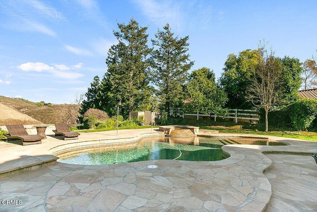 view of pool featuring an in ground hot tub and a patio