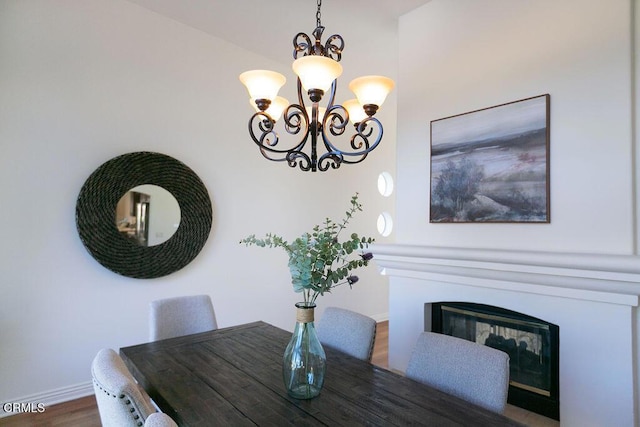 dining space featuring dark wood-type flooring and a notable chandelier